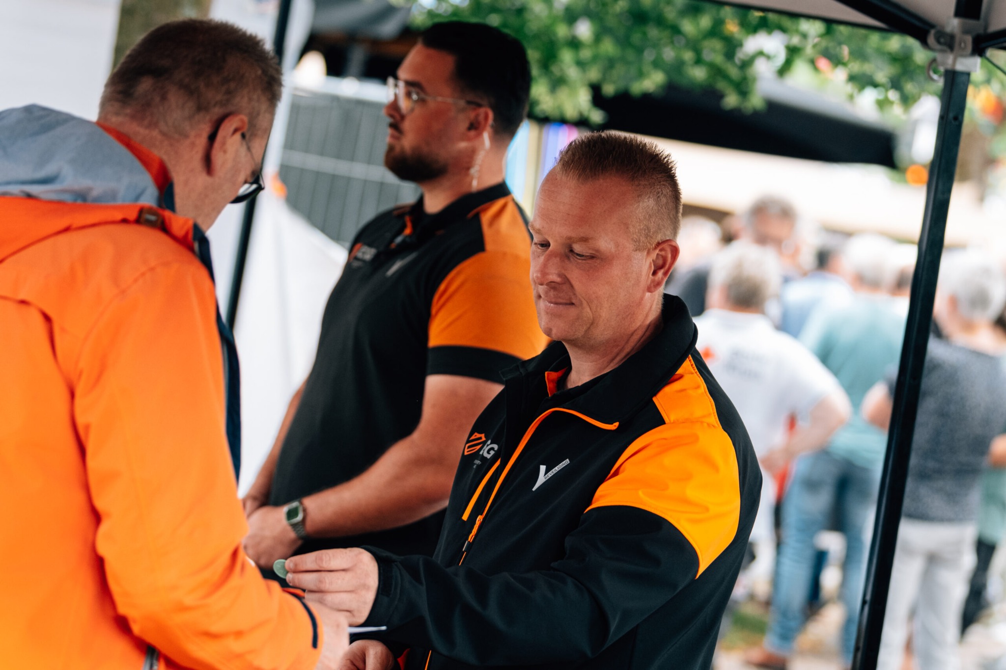 ESG-beveiligers in gesprek met een bezoeker bij de entree